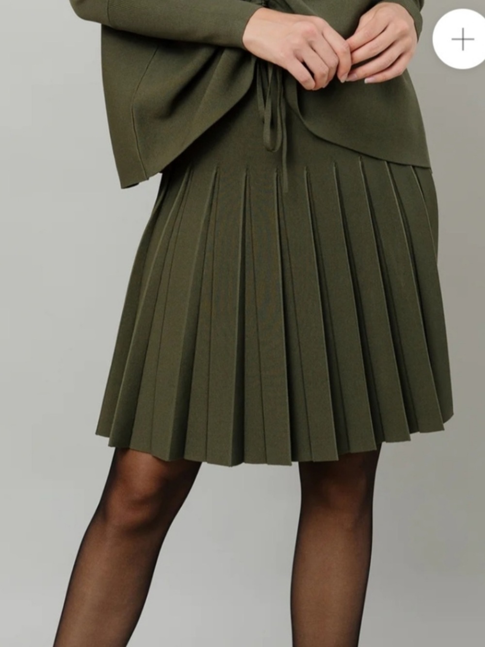 Apparalel olive pleated skirt in longer length than stock photo